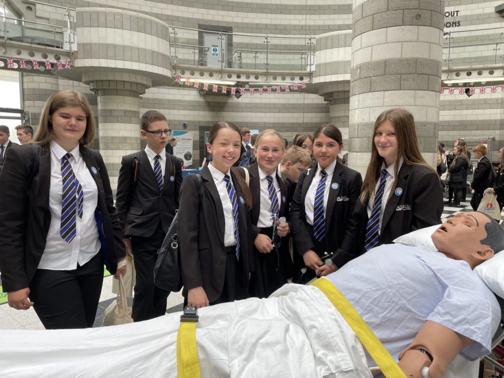 Students interacting with a resuscitation training aid