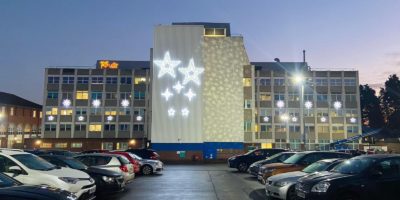 Doncaster Royal Infirmary Christmas stars illuminations to the left, right, and centre of the building. Slightly off centre are the Christmas star illuminations.