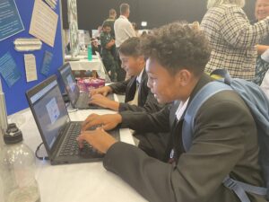 Two students competing against each other in a typing challenge