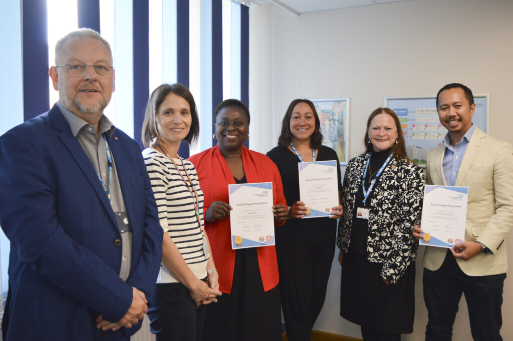 Three programme candidates are posed with their certificates. With them are the Trust's Chief Executive and Chief People Officer and Chair of the Board.