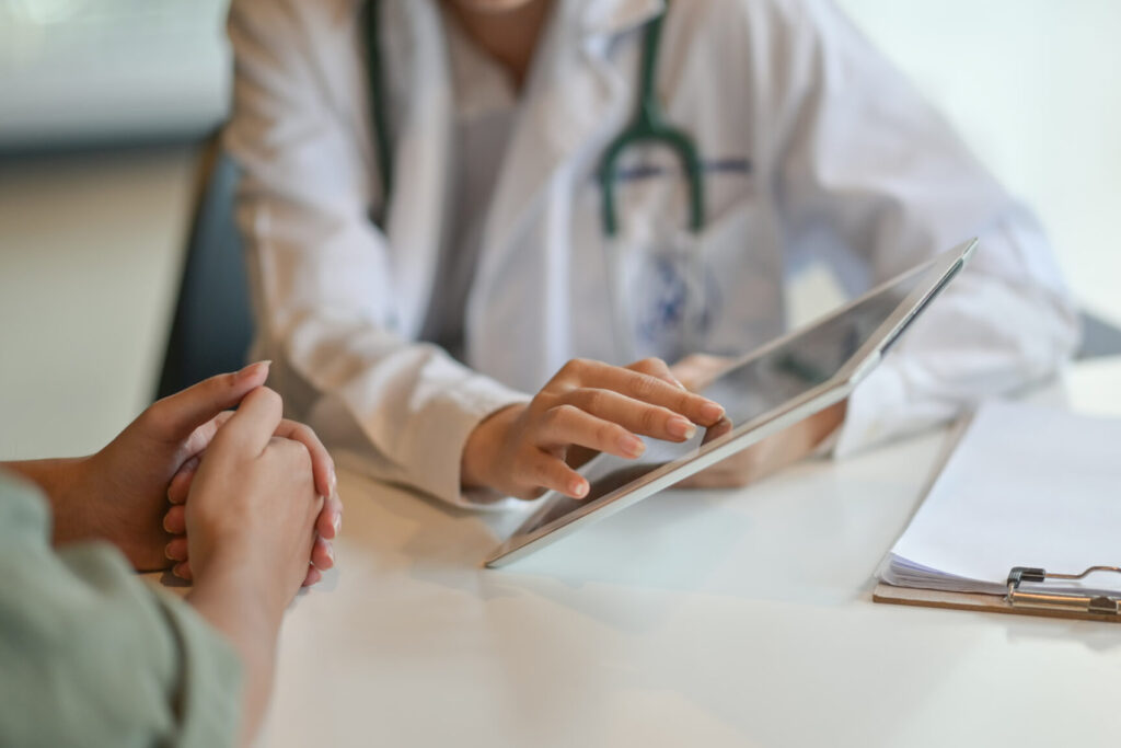 Clinical staff member recording patient details on a handheld device